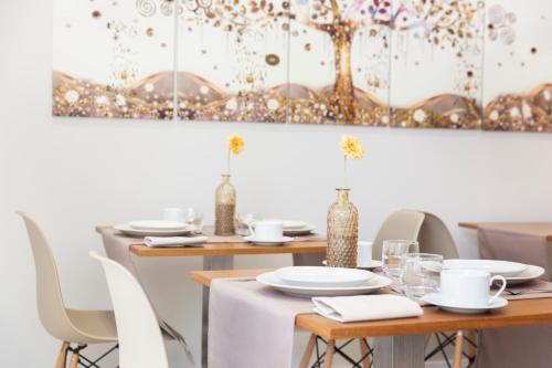 a dining room with tables and chairs and a painting at Urban Sabadell in Sabadell