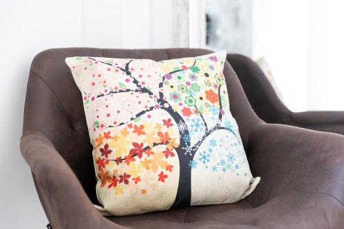 a pillow with a tree pattern on a chair at Urban Sabadell in Sabadell