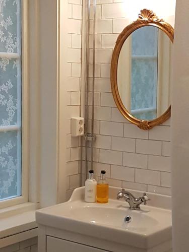 a bathroom with a sink and a mirror at STF Grimsnäs Herrgård in Ljuder