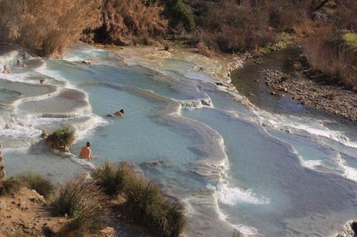 a group of people swimming in a river at Agriturismo La Talpa in Marsiliana