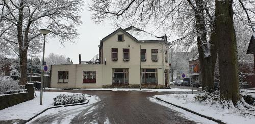 a house on a street in the snow at De Zevende Hemel in Kerkrade