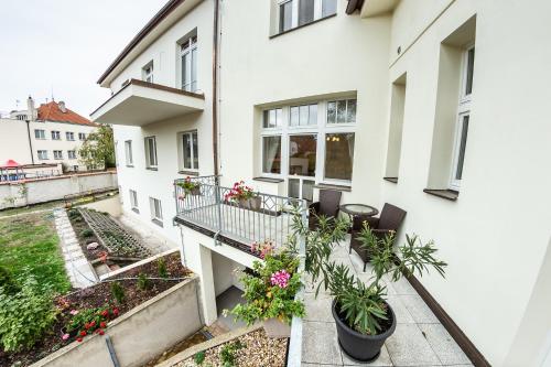 an apartment balcony with plants and flowers at Villa A. Malka in Poděbrady