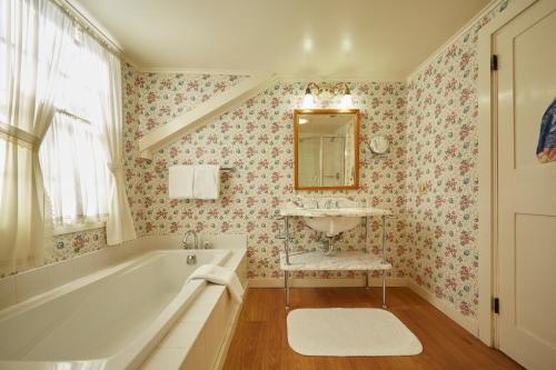 a bathroom with a tub and a sink and a mirror at The Red Lion Inn in Stockbridge