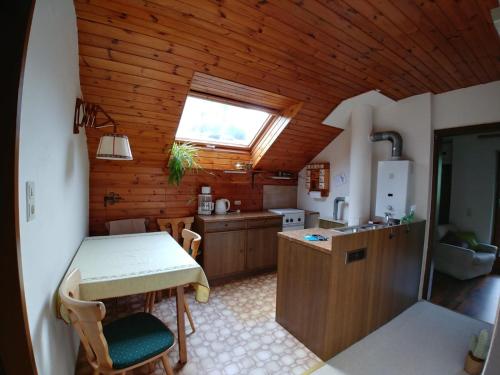 a kitchen with a table and a sink and a window at Apartment Fam. Zappe in Steinhaus am Semmering