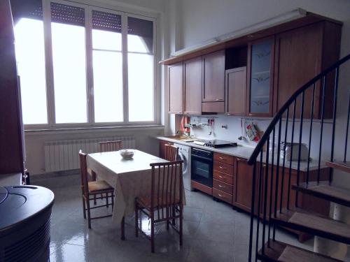 a kitchen with a table and a table and chairs at Appartamenti Lago di Como in Valbrona