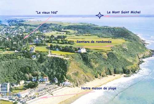 an aerial view of a beach with a lighthouse at "Le Vieux Nid" in Carolles