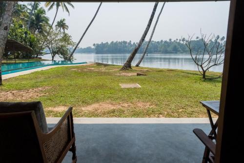 a view of the water from the porch of a house at Cranganor History Café & Riverside Château in Parūr
