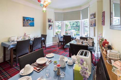 a dining room with tables and chairs in a restaurant at DUNVEGAN in Windermere