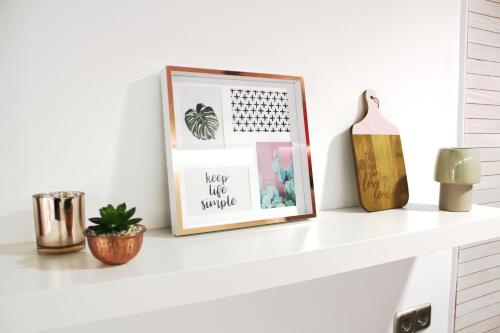 a shelf with a picture and a calendar on it at CHUECA Apartamentos Noxi in Madrid