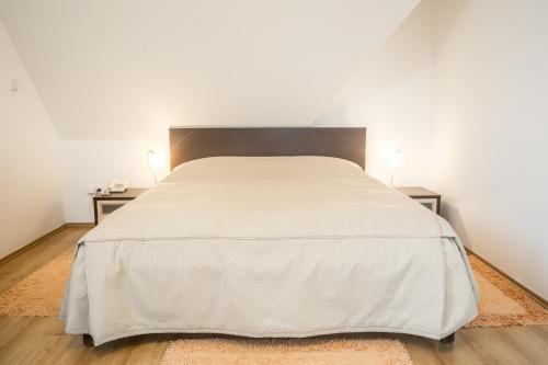 a bedroom with a large bed with two night stands at Villa A. Malka in Poděbrady