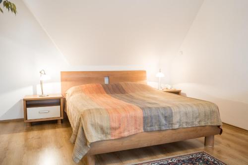 a bedroom with a bed and a nightstand with two lamps at Villa A. Malka in Poděbrady