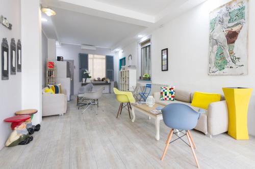 a living room with yellow and white furniture at Hotel Spot Varazze in Varazze