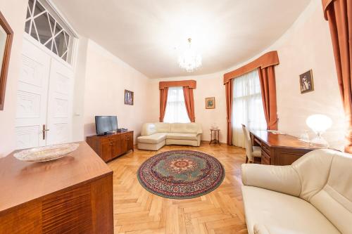 a living room with a couch and a table at Villa A. Malka in Poděbrady