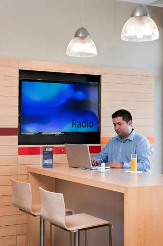a man sitting at a table with a laptop at Ibis Ripollet in Ripollet