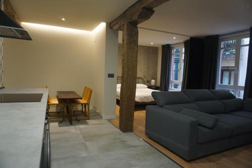 a living room with a couch and a bed at Loft 7calles, Casco Viejo. Bio in Bilbao