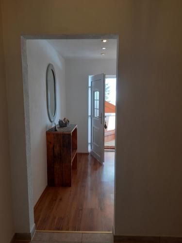 a hallway with a mirror and a dresser in a room at Apartment Birgit in Uderns