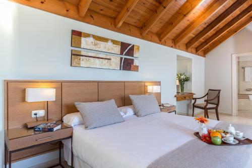 a bedroom with a large white bed and a desk at Ona Alanda Club Marbella in Marbella