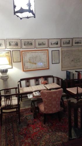a living room with a couch and a table and chairs at Villa Longo de Bellis in Bari