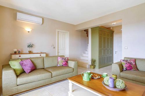 a living room with a couch and a table at Villa Nikolas in Andipáta Erísou