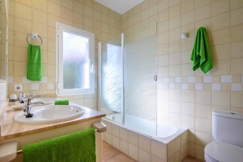 a bathroom with a sink and a shower and a toilet at Villa Paula in Cala'n Porter