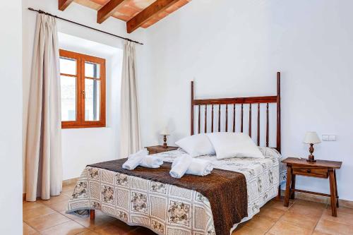 a bedroom with a bed with two towels on it at Villa Mestressa in Santanyi