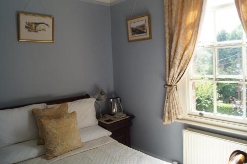 a bedroom with a bed and a window at Foundry Masters House in Ironbridge