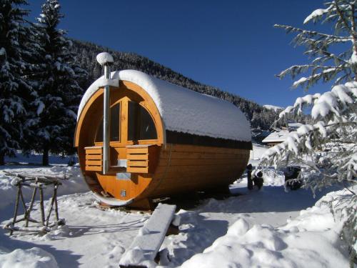 a round cabin in the snow with snow covered trees at Albergo Thurwieser in Santa Caterina Valfurva