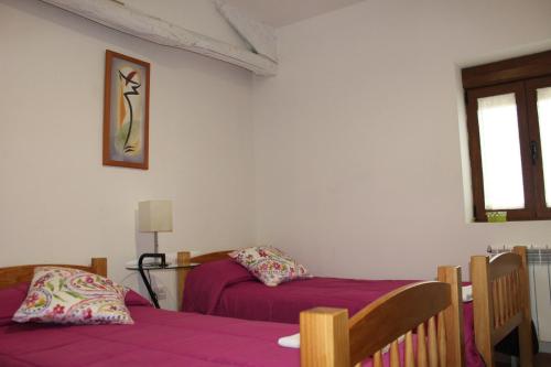A bed or beds in a room at Albergue Vive tu Camino