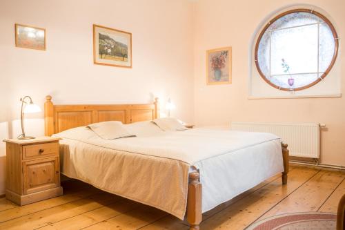 a bedroom with a bed and a round window at Villa A. Malka in Poděbrady