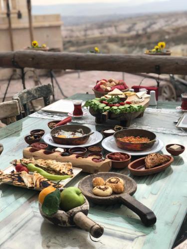 a table with many plates of food on it at Wish Cappadocia in Uchisar
