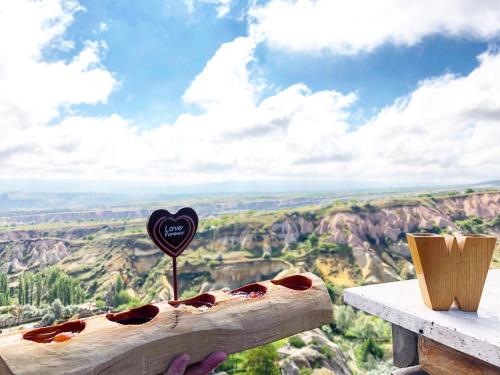 a hot dog on a table with a heart balloon at Wish Cappadocia in Uchisar