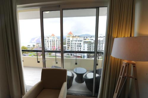 a living room with a view of a large window at Duas Torres - Appartment in Funchal
