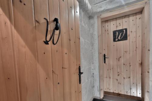 a wooden wall with a door in a room at Wish Cappadocia in Uchisar