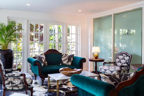a living room with blue furniture and large windows at Coco Palm in Gros Islet