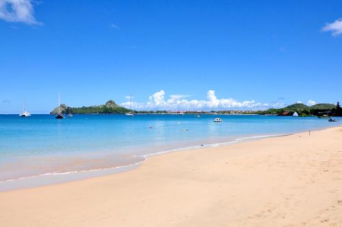 a view of a beach with boats in the water at Coco Palm in Gros Islet