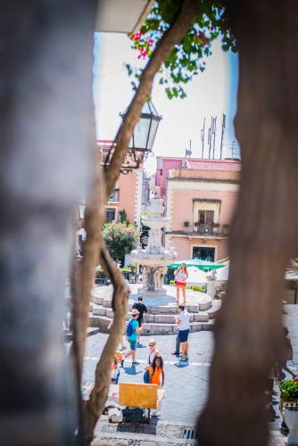 a group of people standing in front of a fountain at Private Villa at Villa al Duomo in Taormina