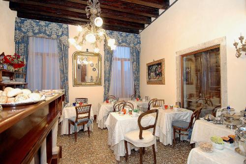 a dining room with two tables with white table cloth at Palazzo Odoni in Venice