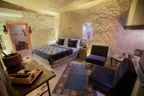 a bedroom with a bed and a living room at Wish Cappadocia in Uchisar