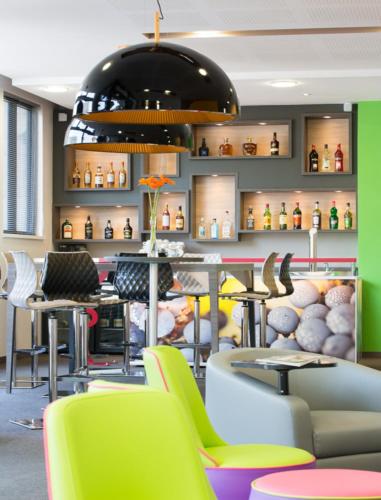 a restaurant with colorful chairs and tables in a room at ibis Styles Strasbourg Centre Petite France in Strasbourg