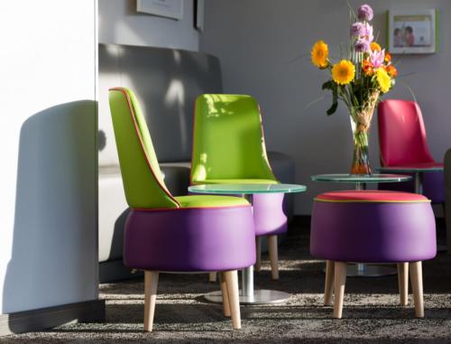 a group of chairs and a table with a vase of flowers at ibis Styles Strasbourg Centre Petite France in Strasbourg