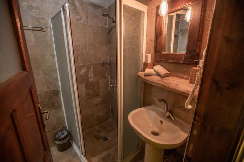 a bathroom with a shower and a sink and a toilet at Wish Cappadocia in Uchisar