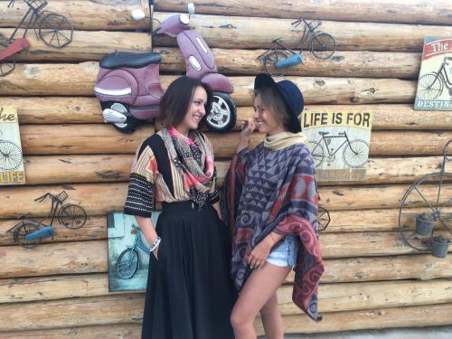 two women are standing in front of a wooden wall at Wish Cappadocia in Uchisar