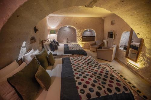 a large room with two beds and a couch at Wish Cappadocia in Uchisar