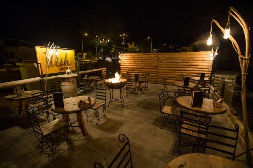 a patio with tables and chairs at night at Wish Cappadocia in Uchisar