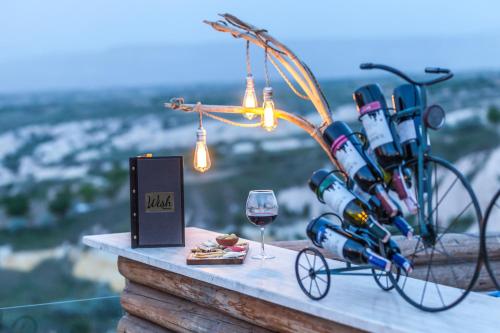 a table with a bike and a glass of wine at Wish Cappadocia in Uchisar