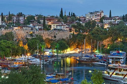 a group of boats docked in a harbor at night at Meyde Boutique Suites in Antalya