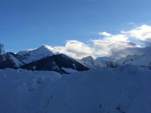 a snow covered mountain with mountains in the background at Anna's Appartement in Alpbach