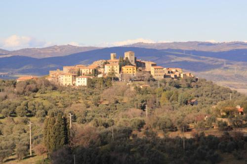 a building on top of a hill with trees at Agriturismo La Talpa in Marsiliana