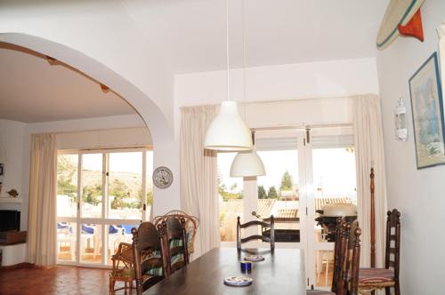 a dining room with a table and chairs and a dining room at Jho'La Surf Camp in Luz
