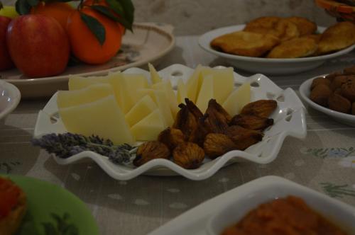 a plate of cheese and nuts on a table at Masseria Giustiniani in Torricella